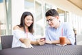 Couple Reading Message On Smartphone In Cafe At Shopping Mall Royalty Free Stock Photo