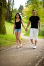 Teenage couple walking on a late summer afternoon in park Royalty Free Stock Photo