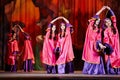 Teenage dancing collective dressed in oriental dress dances