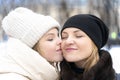 Teenage daughter emotionally kisses mom on the cheek Royalty Free Stock Photo