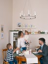 Teenage family whilst eating breakfast together in kitchen Royalty Free Stock Photo