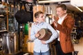 Teenage and father choosing ethnic drum