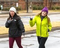 Teenage female cousins walking in the Turkey Trot on Thanksgiving on a cold rainy day in Edmond, Oklahoma Royalty Free Stock Photo