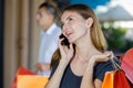 teenage female shopper talking on mobile phone Royalty Free Stock Photo