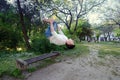 Teenage fitness parkour boy making salto backwards from bench