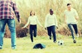 Teenage friends playing football Royalty Free Stock Photo