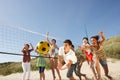 Teenage Friends Playing Volleyball On Beach Royalty Free Stock Photo