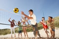 Teenage Friends Playing Volleyball On Beach Royalty Free Stock Photo