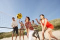 Teenage Friends Playing Volleyball On Beach Royalty Free Stock Photo