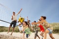 Teenage Friends Playing Volleyball On Beach Royalty Free Stock Photo