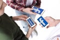 Teenage friends using smartphones with facebook logo isolated on white