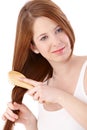 Teenage ginger girl combing long hair