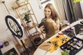 Teenage girl accessories designer making handmade jewelry in studio workshop and recording video. Royalty Free Stock Photo