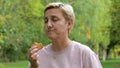 A teenage girl with an Asian appearance chews up leftovers and laughs with crumbs from her mouth. selective focus