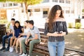 Teenage girl avoiding her friends to check her phone Royalty Free Stock Photo