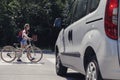 Girl with backpack and bike on pedestrian crossing