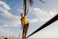 Teenage girl balancing on slackline with sky view Royalty Free Stock Photo