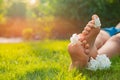 Teenage girl with beautiful hortensia flowers lying on green grass outdoors, closeup. Space for text Royalty Free Stock Photo