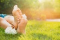 Teenage girl with beautiful hortensia flowers lying on green grass outdoors, closeup. Space for text Royalty Free Stock Photo