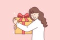 Teenage girl with big gift box with red ribbon smiling overjoyed at unexpected surprise