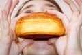 A teenage girl bites off a sweet, delicious bun Royalty Free Stock Photo