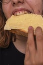 teenage girl bites a sandwich cheese Royalty Free Stock Photo