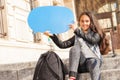 Teenage girl with blanked blue speech bubble Royalty Free Stock Photo