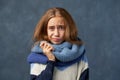 Teenage girl blonde in warm sweater isolated wall Royalty Free Stock Photo