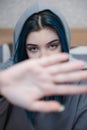 A teenage girl with blue hair covers her face with her hand Royalty Free Stock Photo