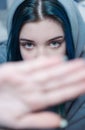 A teenage girl with blue hair covers her face with her hand Royalty Free Stock Photo