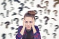 Teenage girl and blurred question marks Royalty Free Stock Photo