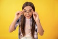 teenage girl can see with eyesight glasses. teenage girl in eyesight eyeglasses look somewhere. girl with eyesight Royalty Free Stock Photo