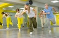Teenage girl in cap training breakdance Toprock moves in dance hall