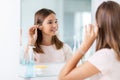 teenage girl cleaning ear with cotton swab Royalty Free Stock Photo