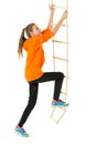Teenage girl climbing rope ladder. Isolated over white background. Royalty Free Stock Photo