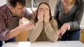 Teenage girl crying and closing face with hands after conflict with parents. Family violence, conflicts and relationship