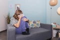 Teenage girl crying on the couch in the therapy room during her session. Royalty Free Stock Photo