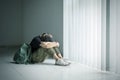 Teenage girl crying near the window Royalty Free Stock Photo