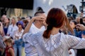 Teenage girl dancing at a street concert in city