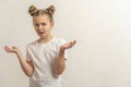 Teenage girl with dark hair hair in a white t-shirt on a light background wonder Royalty Free Stock Photo