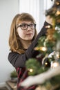 Teenage girl decorating Christmas tree at home Royalty Free Stock Photo