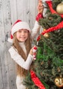 Teenage girl decorating New Year tree at home Royalty Free Stock Photo