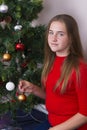 Teenage girl decorating New Year tree Royalty Free Stock Photo