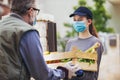 Teenage girl is delivering some groceries to an elderly person, during the epidemic coronovirus Royalty Free Stock Photo