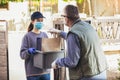 Teenage girl is delivering some groceries to an elderly person, during the epidemic coronovirus