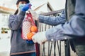 Teenage girl is delivering some groceries to an elderly person, during the epidemic coronovirus Royalty Free Stock Photo