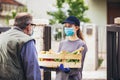 Girl is delivering some groceries to an elderly person, during the epidemic coronovirus, COVID-19 Royalty Free Stock Photo