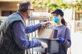 Girl is delivering some groceries to an elderly person, during the epidemic coronovirus, COVID-19 Royalty Free Stock Photo