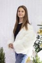 teenage girl demonstrates winter clothes white fluffy faux fur coat Royalty Free Stock Photo