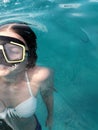 A teenage girl diving with swim mask wearing swimsuit in a clean water of mediteran sea